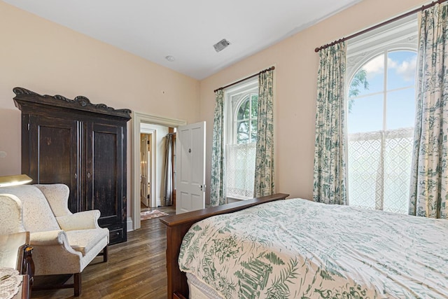 bedroom featuring dark wood-style floors and visible vents