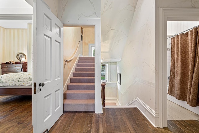 stairs featuring wood finished floors