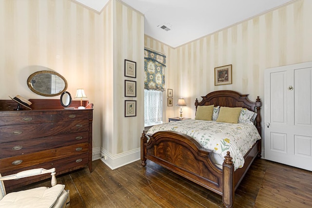 bedroom featuring wallpapered walls, dark wood-style flooring, and baseboards