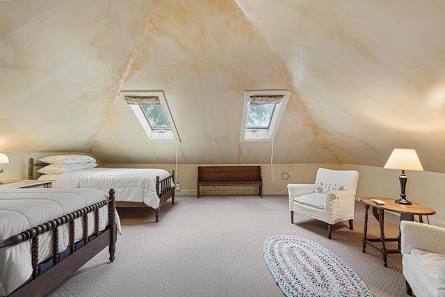 bedroom with vaulted ceiling with skylight and carpet flooring