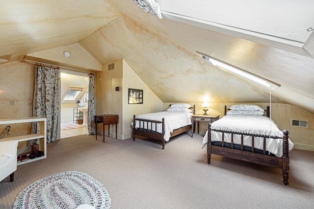 bedroom featuring vaulted ceiling, carpet flooring, and visible vents