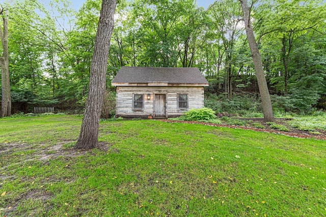 view of front facade with an outbuilding and a front lawn