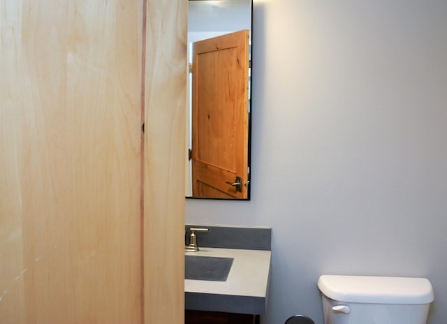 bathroom with vanity with extensive cabinet space and toilet