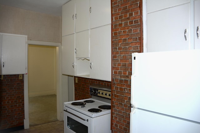 kitchen with tile flooring, white cabinetry, and white appliances