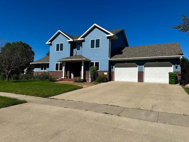 view of front facade featuring a front yard, an attached garage, brick siding, and driveway