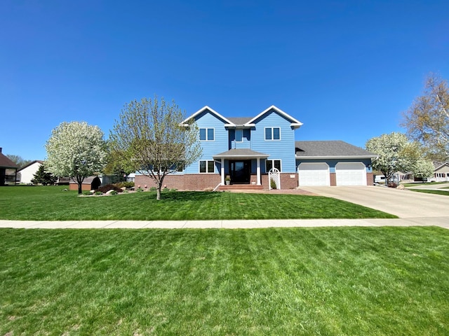 view of front of house with driveway, a front yard, brick siding, and an attached garage