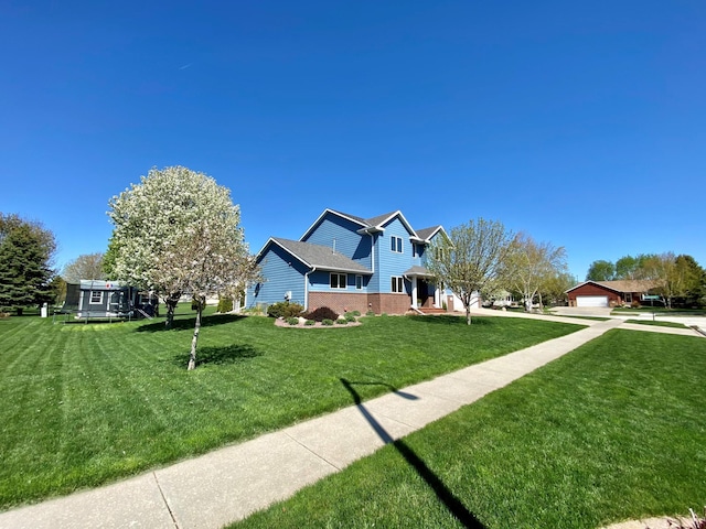 exterior space featuring a garage, brick siding, and a front lawn