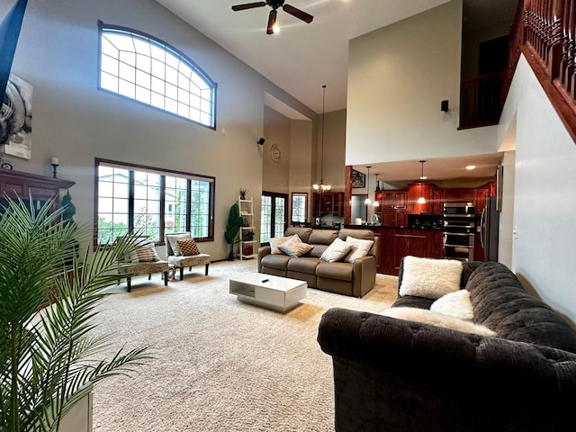living room featuring a ceiling fan and light colored carpet