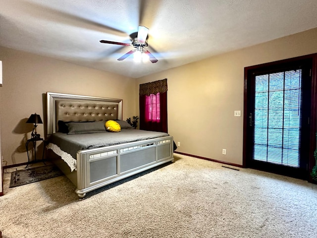 carpeted bedroom featuring visible vents, ceiling fan, a textured ceiling, and baseboards