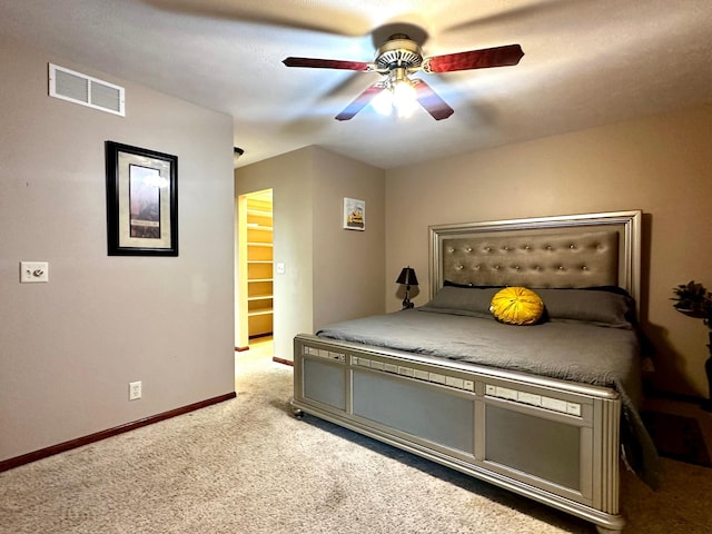bedroom with light carpet, visible vents, ceiling fan, and baseboards