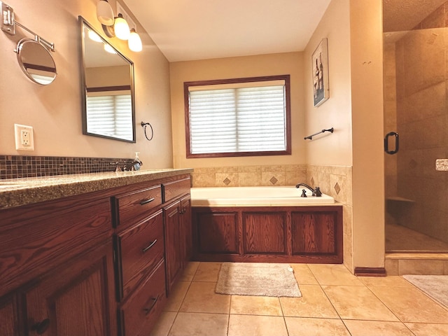 full bath featuring tile patterned floors, vanity, a bath, and a shower stall