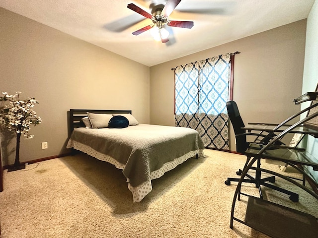 bedroom with a ceiling fan, baseboards, and carpet floors