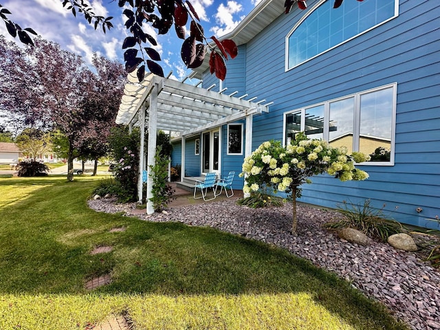 view of home's exterior featuring a patio, a lawn, and a pergola