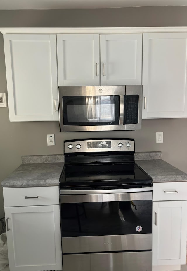 kitchen with white cabinetry and stainless steel appliances