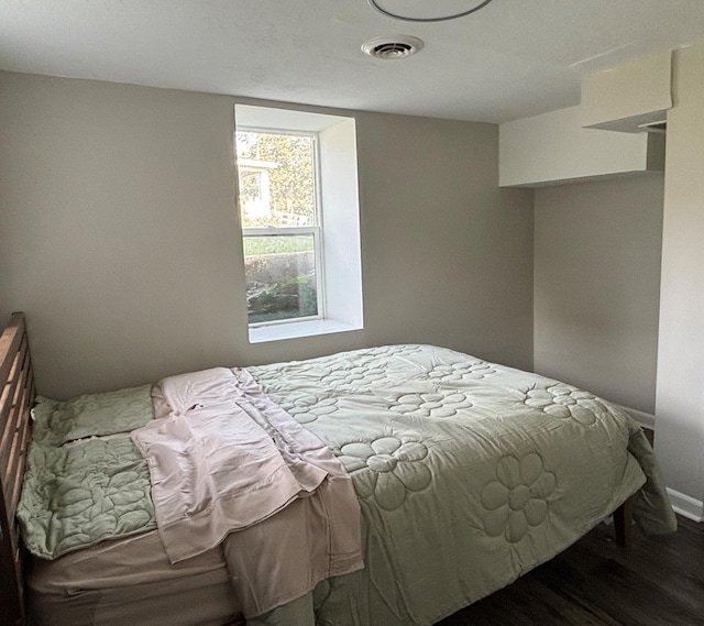 bedroom with dark wood-type flooring