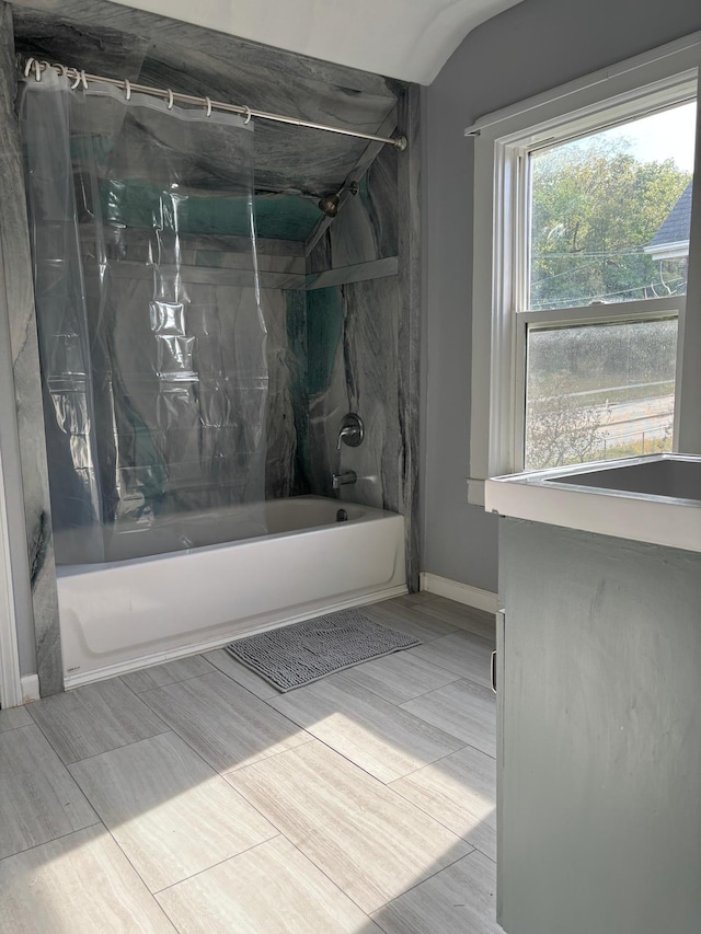 bathroom featuring hardwood / wood-style flooring and tiled shower / bath