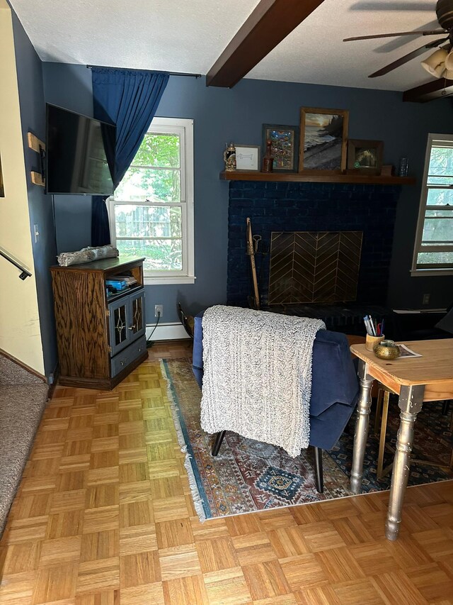 living room featuring beamed ceiling, a baseboard radiator, parquet flooring, ceiling fan, and a textured ceiling