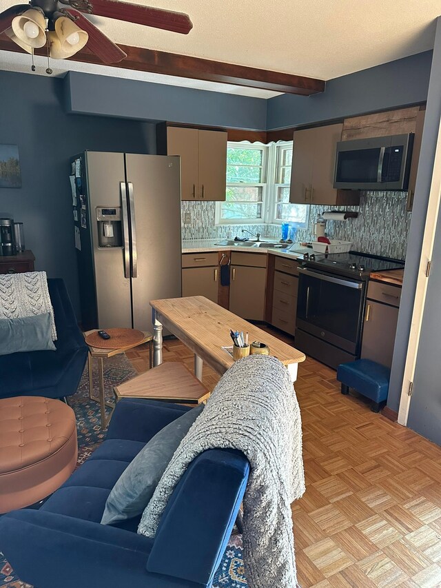 kitchen featuring a textured ceiling, backsplash, ceiling fan, light parquet floors, and appliances with stainless steel finishes