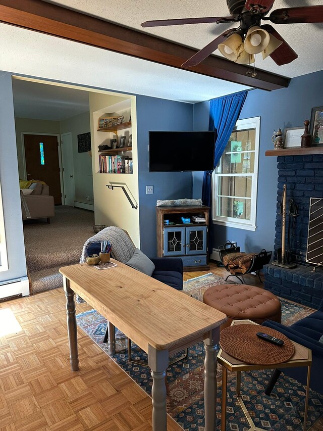 living room featuring a fireplace, a textured ceiling, a baseboard radiator, and ceiling fan