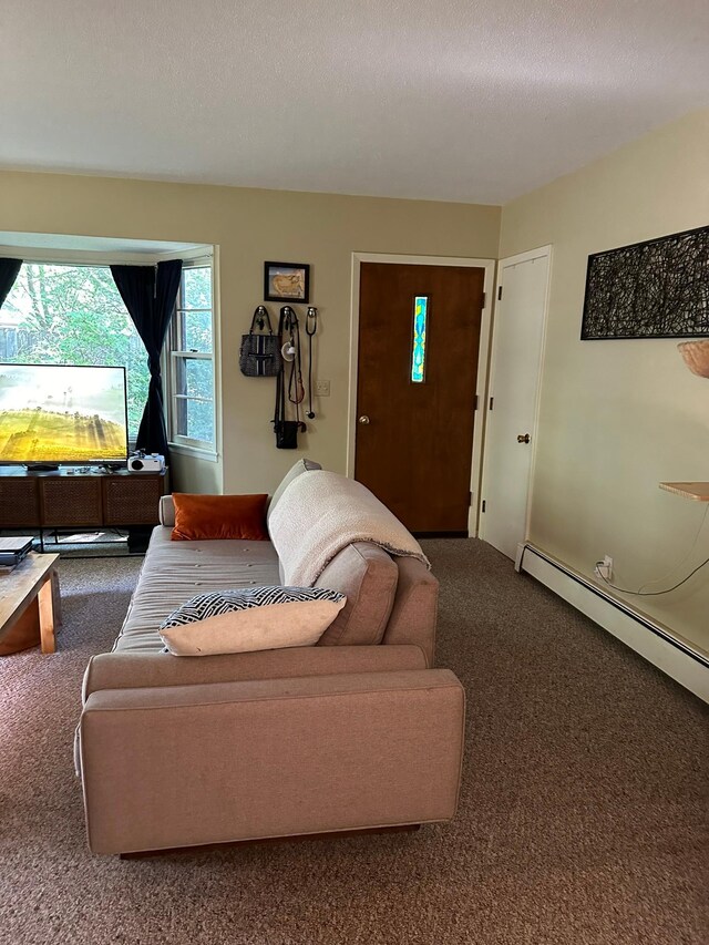 living room featuring a textured ceiling, a baseboard radiator, and carpet