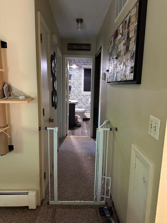 corridor featuring a baseboard radiator and carpet flooring