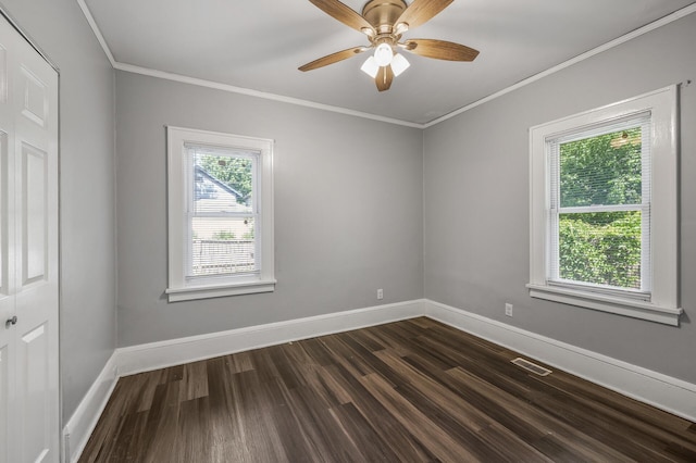 unfurnished room with a healthy amount of sunlight, crown molding, dark hardwood / wood-style floors, and ceiling fan