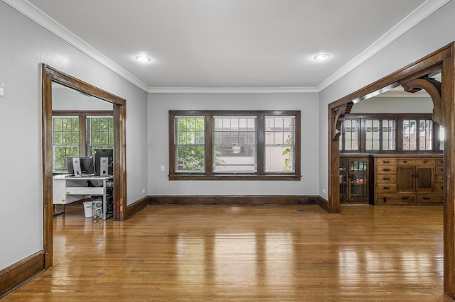 interior space with ornamental molding and hardwood / wood-style floors