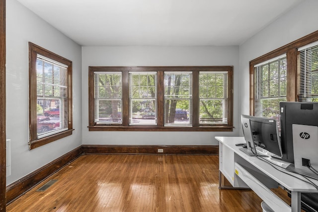 home office with hardwood / wood-style flooring