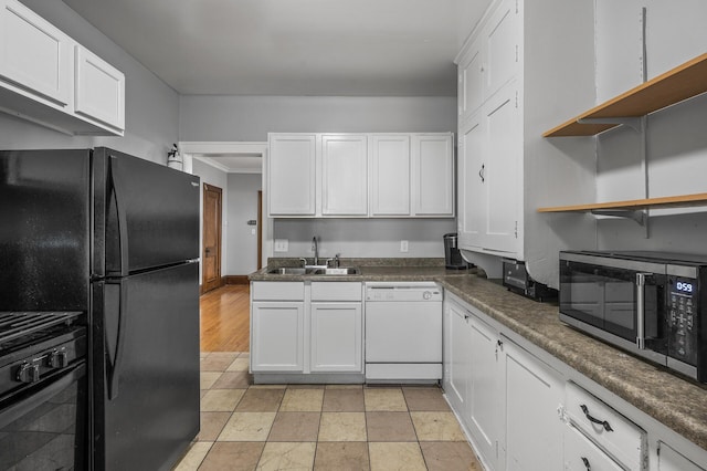 kitchen with black appliances, sink, and white cabinets