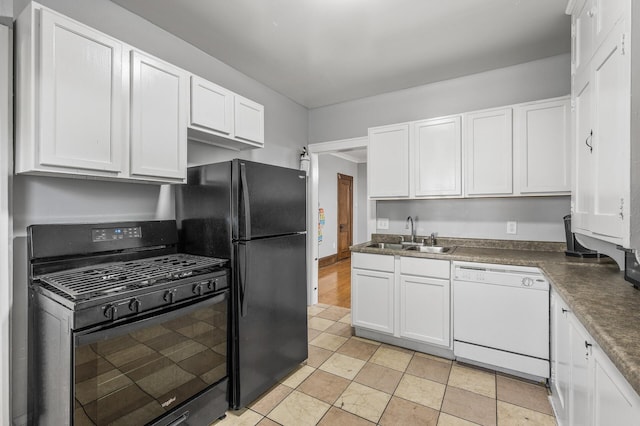 kitchen featuring black appliances, white cabinetry, and sink