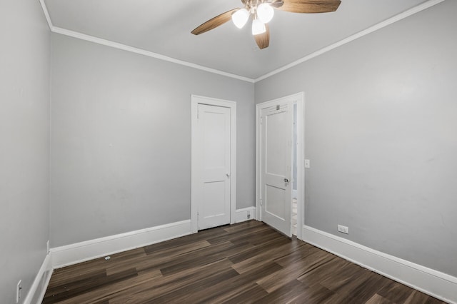 empty room featuring ceiling fan, dark hardwood / wood-style floors, and ornamental molding