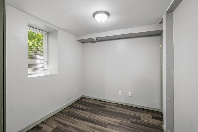 spare room featuring dark wood-type flooring