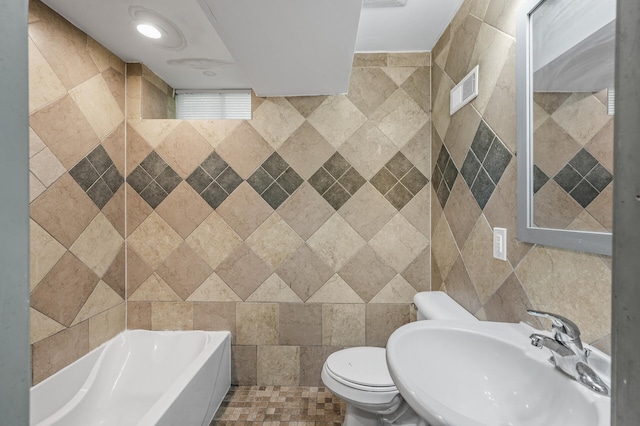 bathroom featuring tile walls, tile patterned flooring, sink, a tub to relax in, and toilet