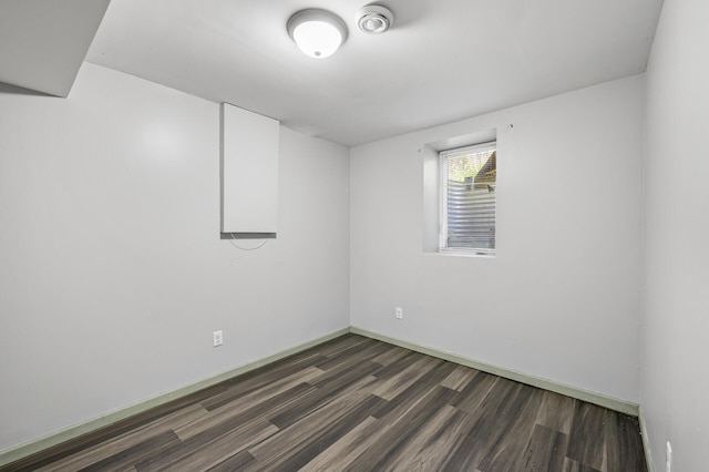 empty room with dark hardwood / wood-style floors