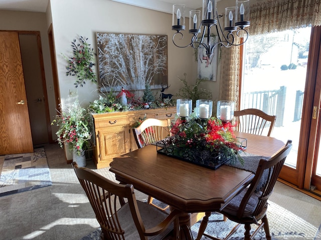 dining area featuring a wealth of natural light and an inviting chandelier