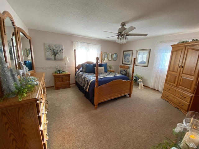 carpeted bedroom featuring ceiling fan and a textured ceiling