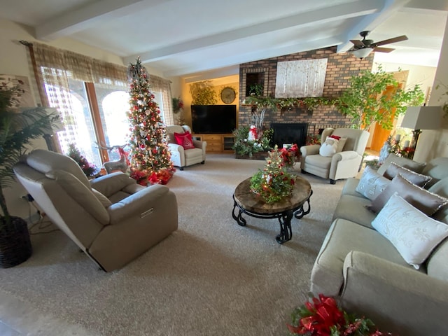 carpeted living room with vaulted ceiling with beams, ceiling fan, and a brick fireplace