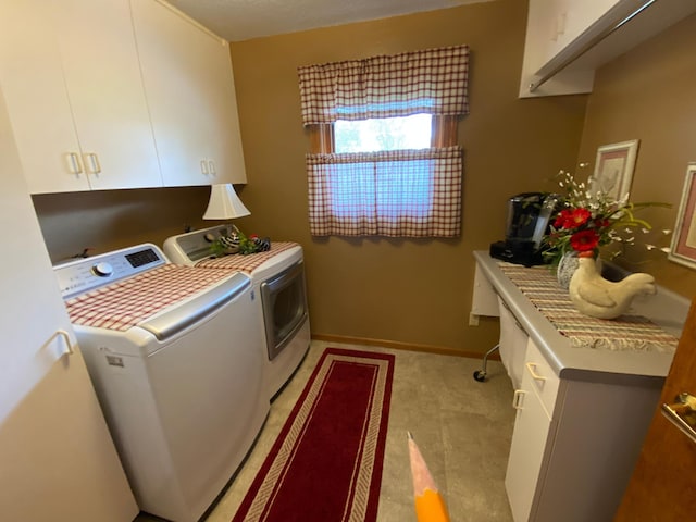 laundry room with cabinets and separate washer and dryer