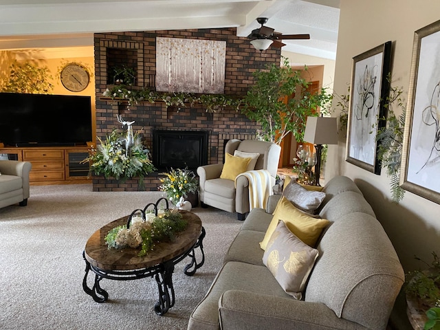 carpeted living area featuring lofted ceiling with beams, ceiling fan, and a fireplace