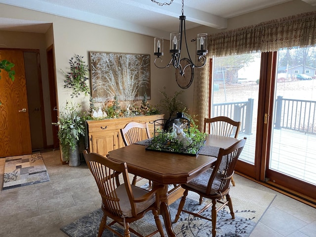 dining space featuring a chandelier, beam ceiling, and a wealth of natural light