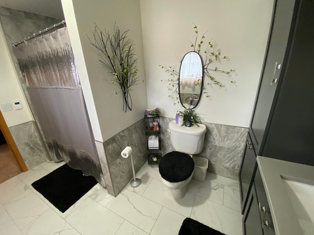 bathroom with a shower with curtain, marble finish floor, a sink, and toilet