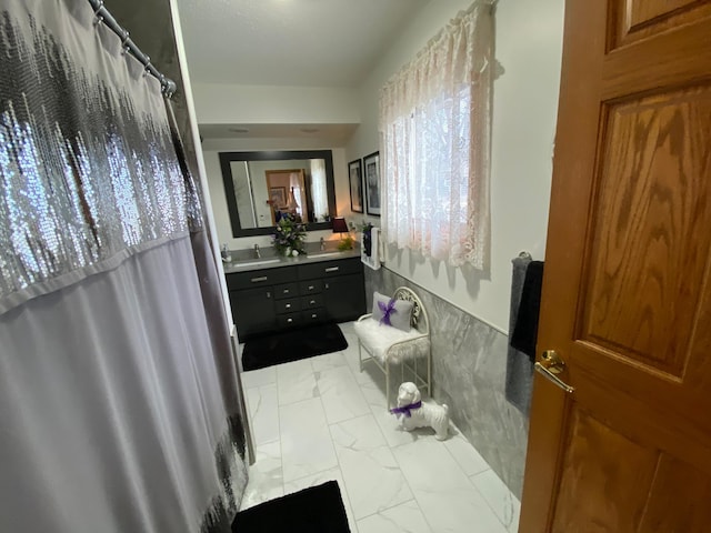 bathroom featuring a shower with curtain, marble finish floor, and vanity