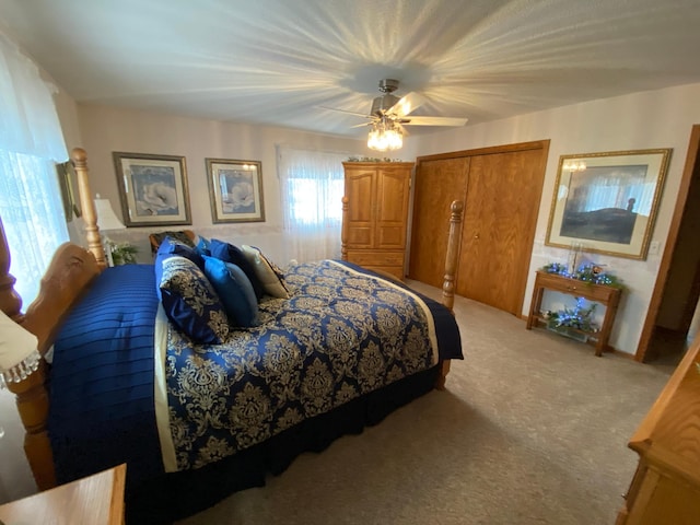 bedroom with light carpet and ceiling fan