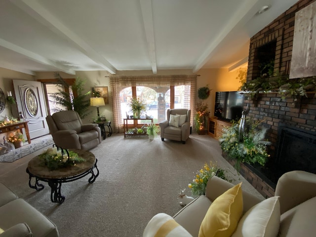 carpeted living area featuring beam ceiling and a fireplace