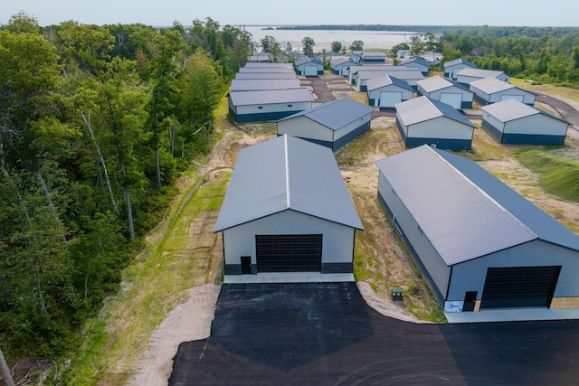 aerial view featuring a wooded view and a residential view