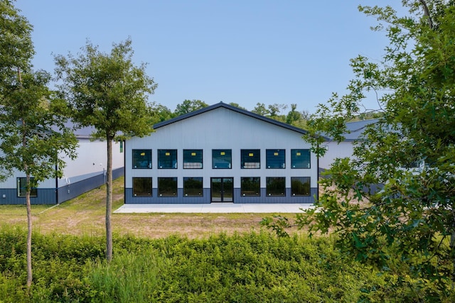 rear view of house featuring a yard