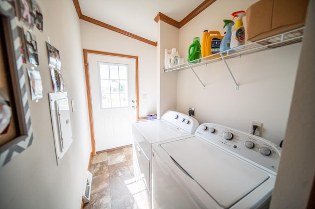 laundry area with light tile patterned floors, washer and dryer, and crown molding