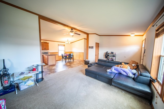 carpeted living room with ceiling fan and ornamental molding