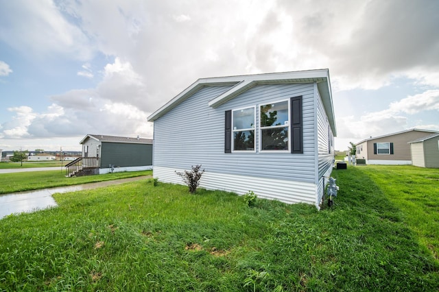 view of side of home featuring a lawn