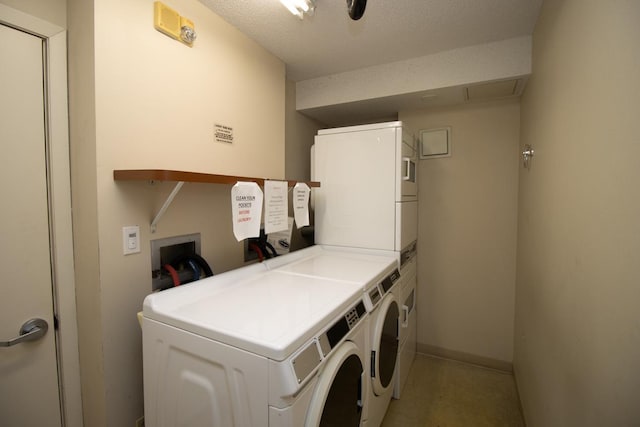 laundry room with stacked washer / dryer, washer and clothes dryer, and a textured ceiling